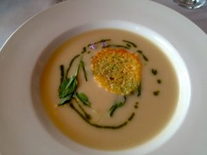 Potato soup garnished with ramp leaves, at the new Stonington restaurant, Aragosta.